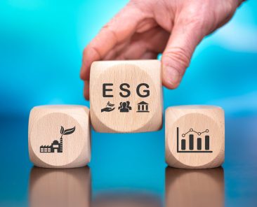 Wooden blocks with symbol of esg concept on blue background
