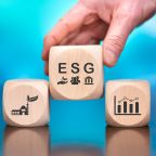 Wooden blocks with symbol of esg concept on blue background